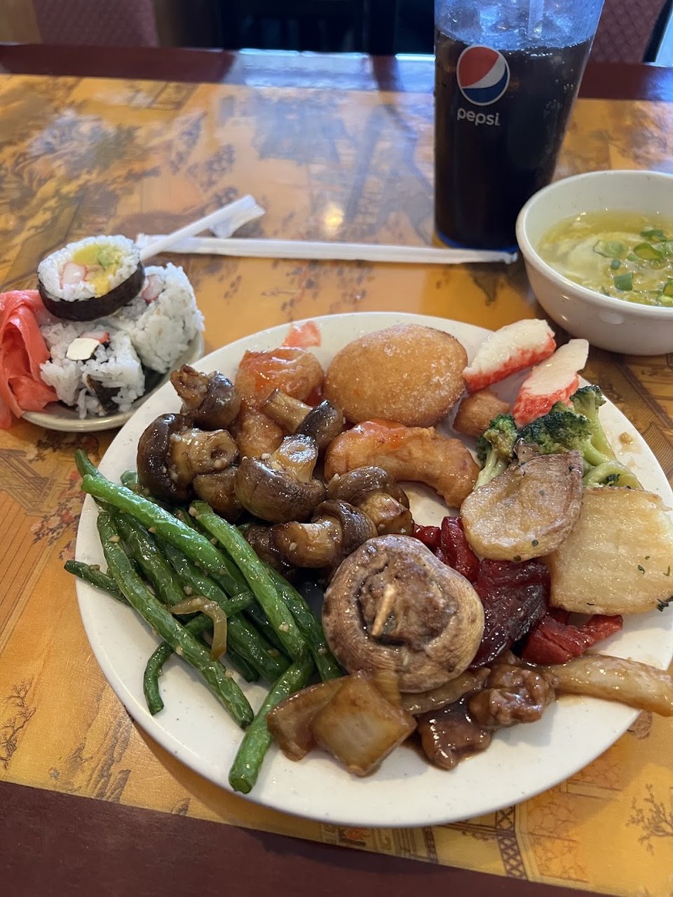 Printed menu with sushi rolls and buffet choices.