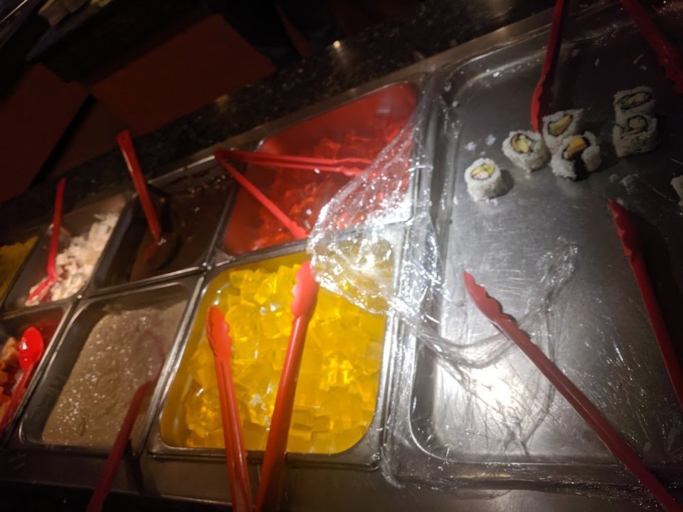 Printed menu with sushi rolls and buffet choices.